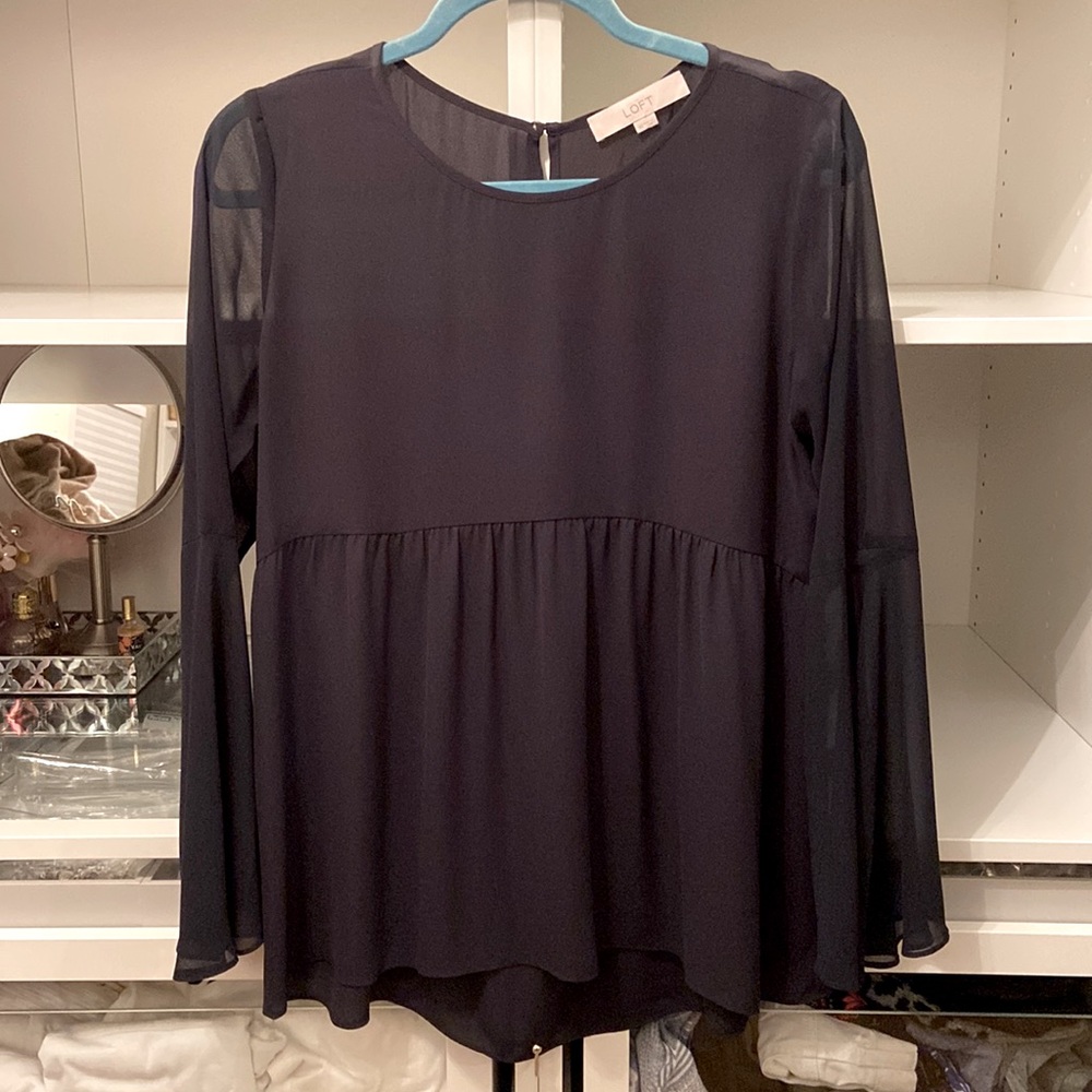 Blue silky fabric blouse with button neck closure in back